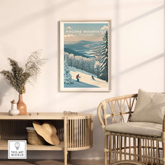 Pocono Mountains ski run poster displayed in a stylish living room, featuring winter mountain scenery and skiers.