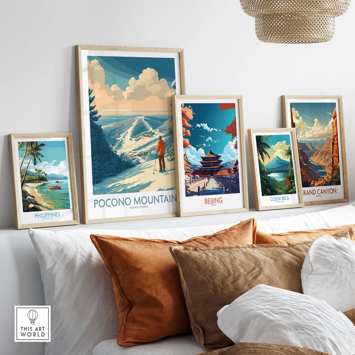 Collection of travel posters including Pocono Mountains, Beijing, Costa Rica, Grand Canyon, and Philippines displayed in a cozy setting.