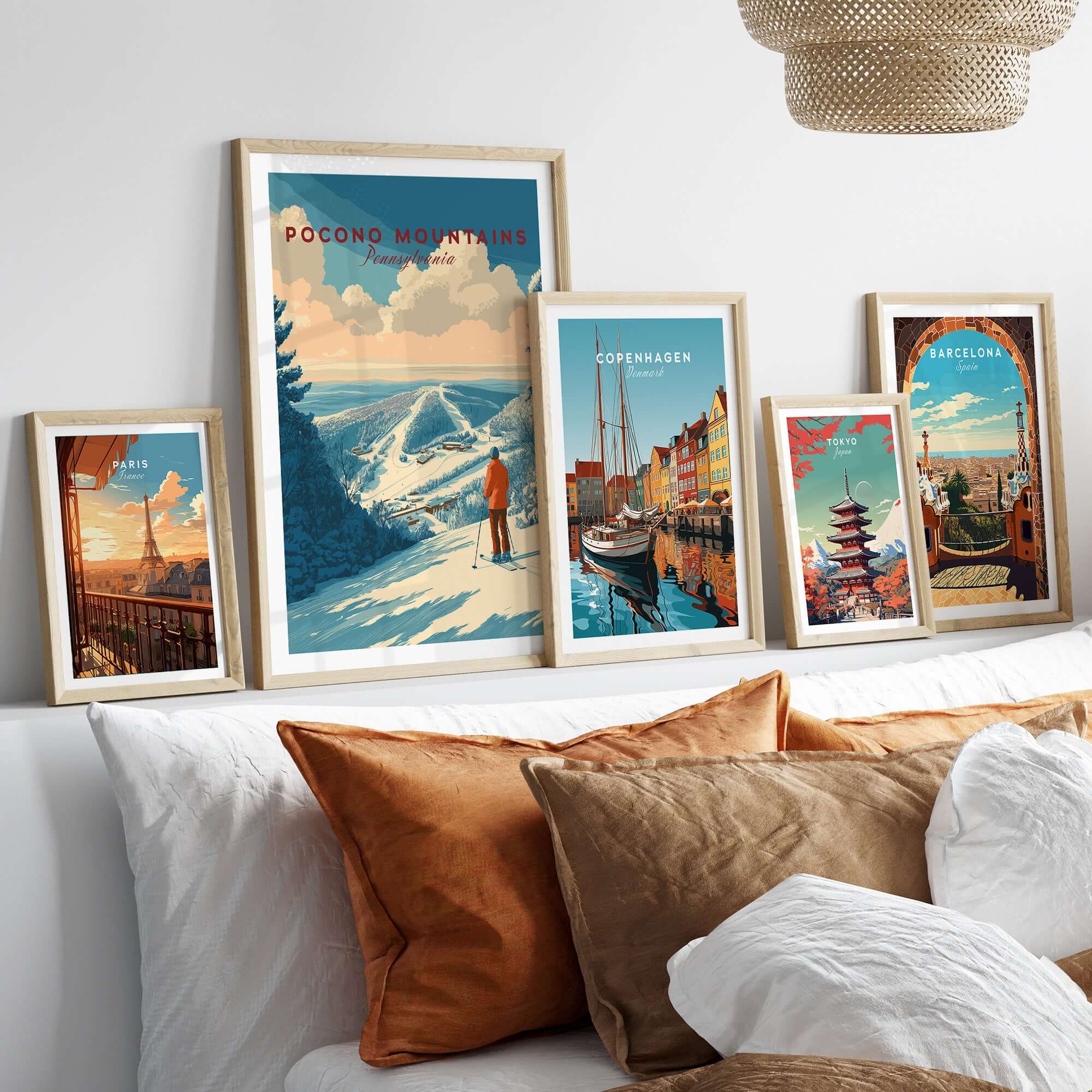 Pocono Mountains Ski Print showcasing scenic landscapes and travel posters framed on a stylish bed setting.