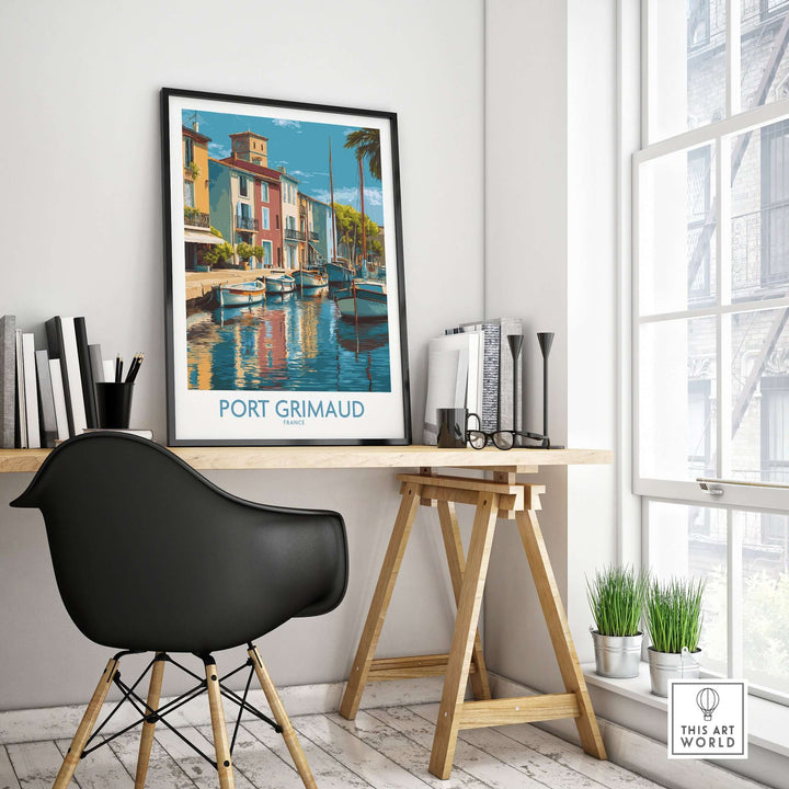 Port Grimaud poster featuring vibrant boats and buildings in a stylish workspace, French Riviera wall art decor.