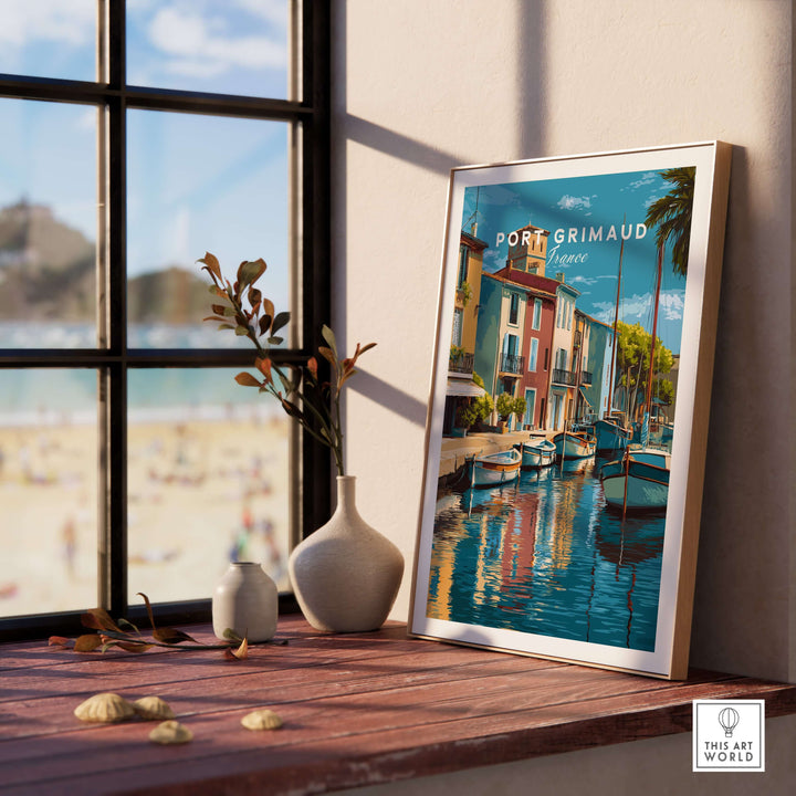 Framed Port Grimaud village art print showcasing colorful boats and reflections by a sunny window.