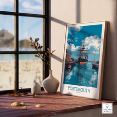 Portsmouth England Art Print | Naval Dockyard Poster displayed in a cozy interior setting with a view of the beach.
