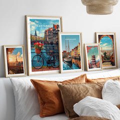 Amsterdam poster with bike and tulips, displayed with various travel-themed art prints above a cozy sofa.