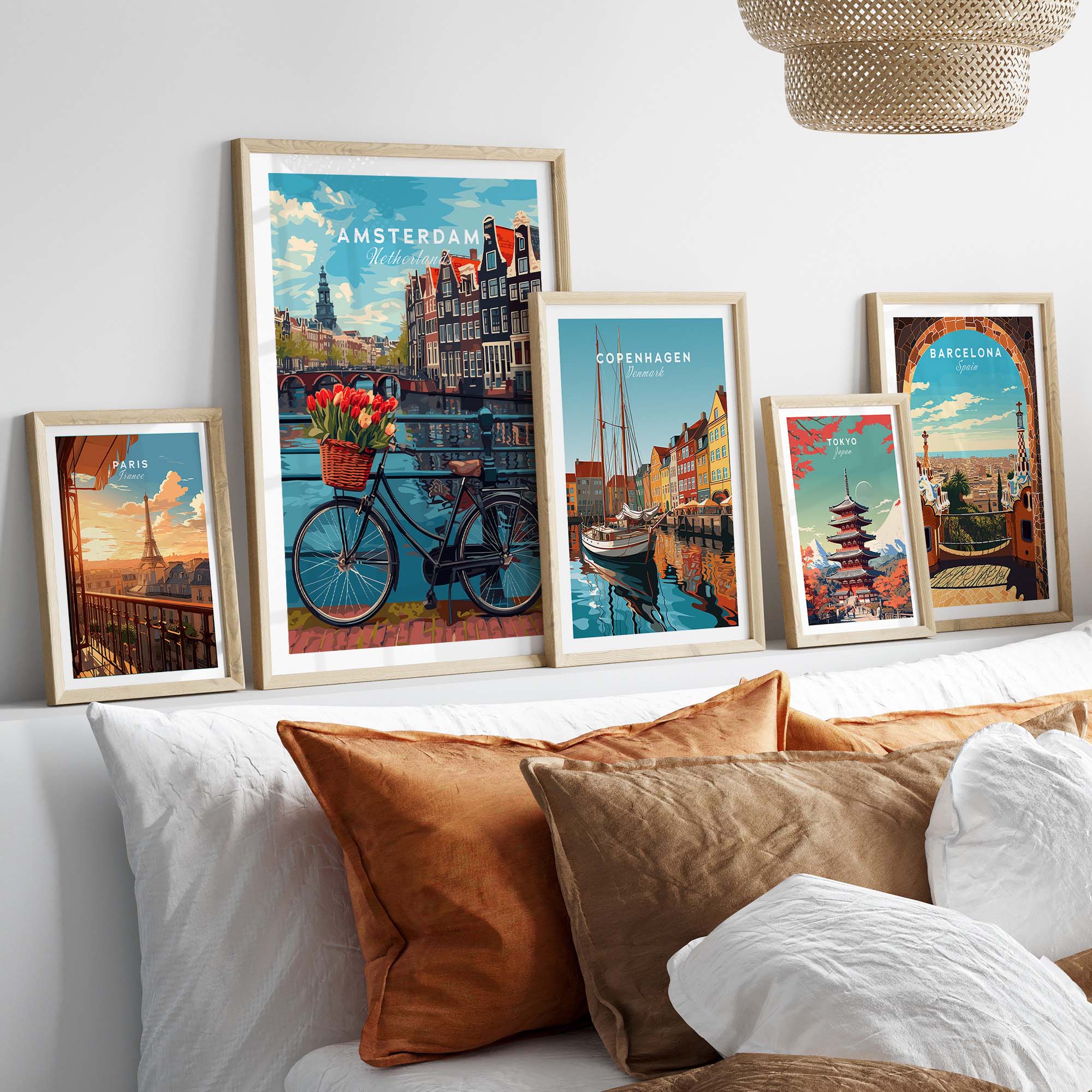 Amsterdam poster with bike and tulips, displayed with various travel-themed art prints above a cozy sofa.