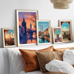 Prague Poster and other European city travel posters in stylish frames on a cozy sofa.