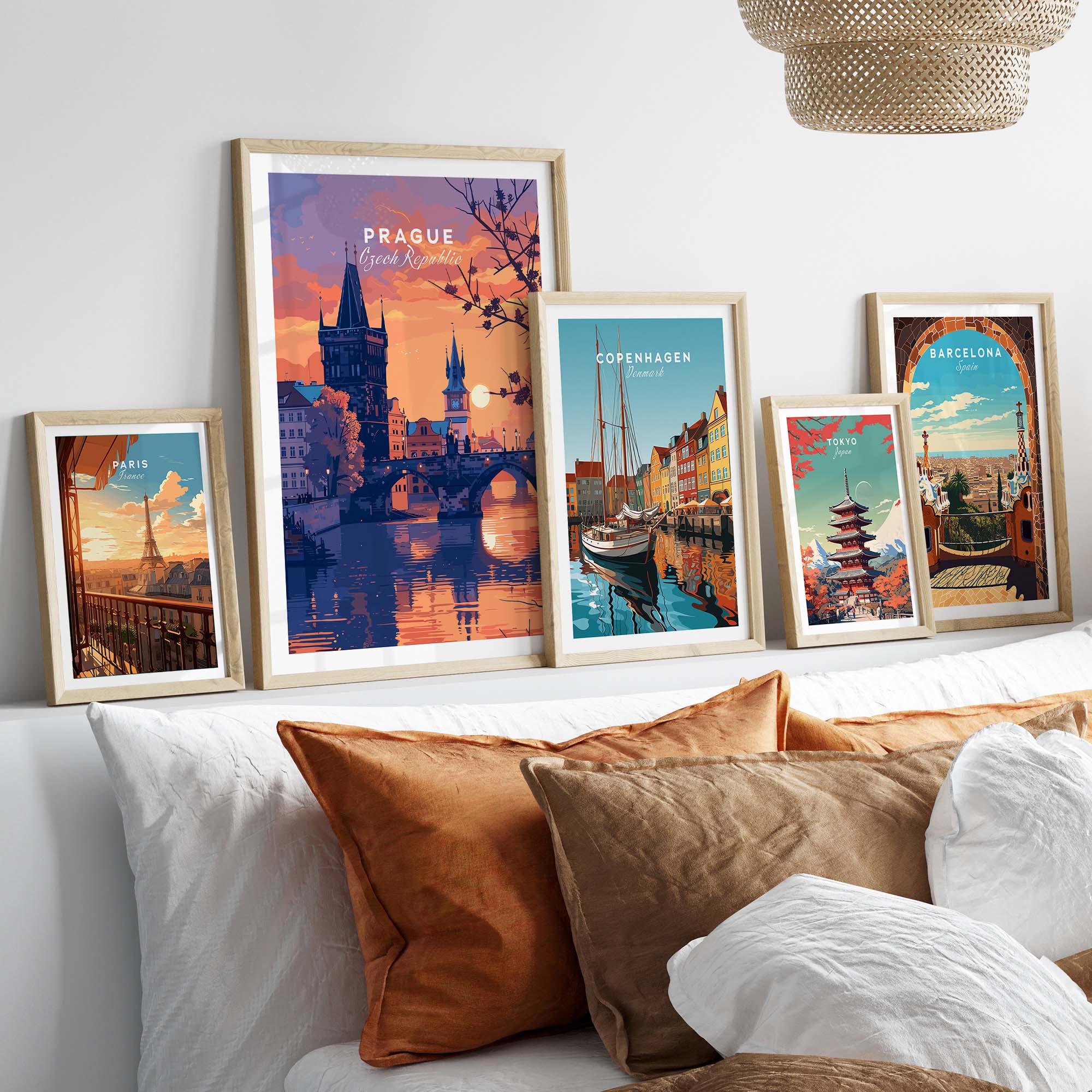 Prague Poster and other European city travel posters in stylish frames on a cozy sofa.