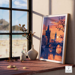 Prague Poster showcasing a sunset view of the city, framed on a wooden table near a window.