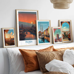 Prizren Kosovo Sunset Art Print | River Bistrica View Poster displayed among other travel art prints on a stylish sofa.