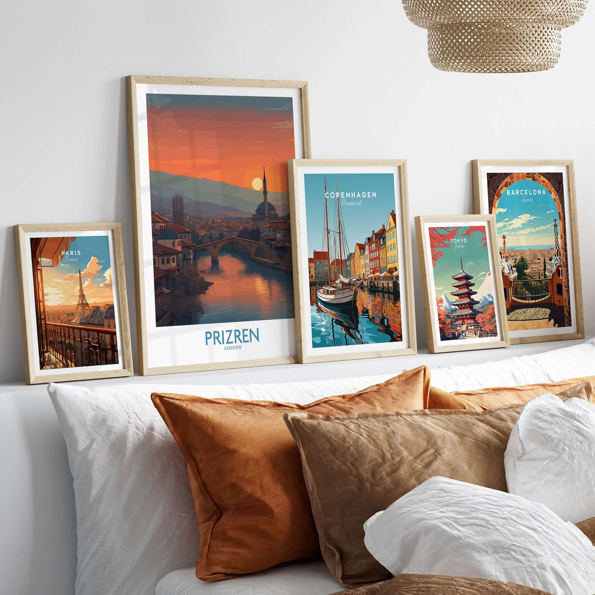 Prizren Kosovo Sunset Art Print | River Bistrica View Poster displayed among other travel art prints on a stylish sofa.