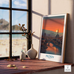 Prizren Kosovo Sunset Art Print | River Bistrica View Poster displayed on a windowsill with a serene riverside landscape.
