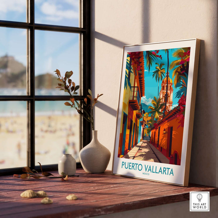 Puerto Vallarta poster featuring vibrant street scene, showcasing the beauty and culture of Mexico, displayed on a windowsill with beach view.