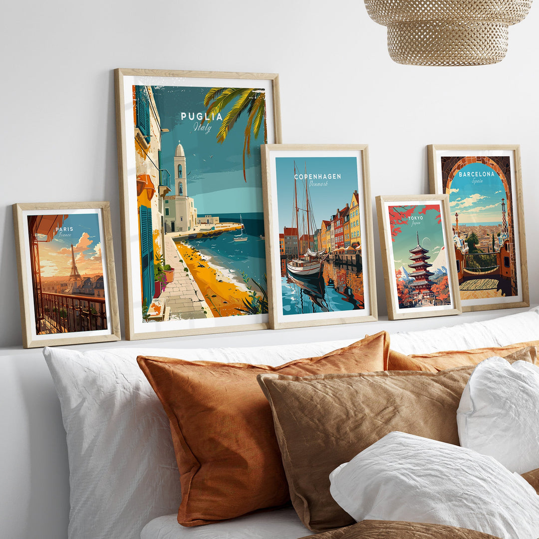 Puglia Wall Art Print displayed among other travel posters from Copenhagen and Barcelona in a cozy room setting.