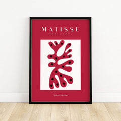 Matisse Art Prints - Red Coral Abstract Black Diamonds Poster showcased in a modern black frame on a wooden floor.