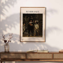 Rembrandt The Night Watch 1642 Famous Dutch Master Painting Art Print Poster displayed on a wall next to decorative items.