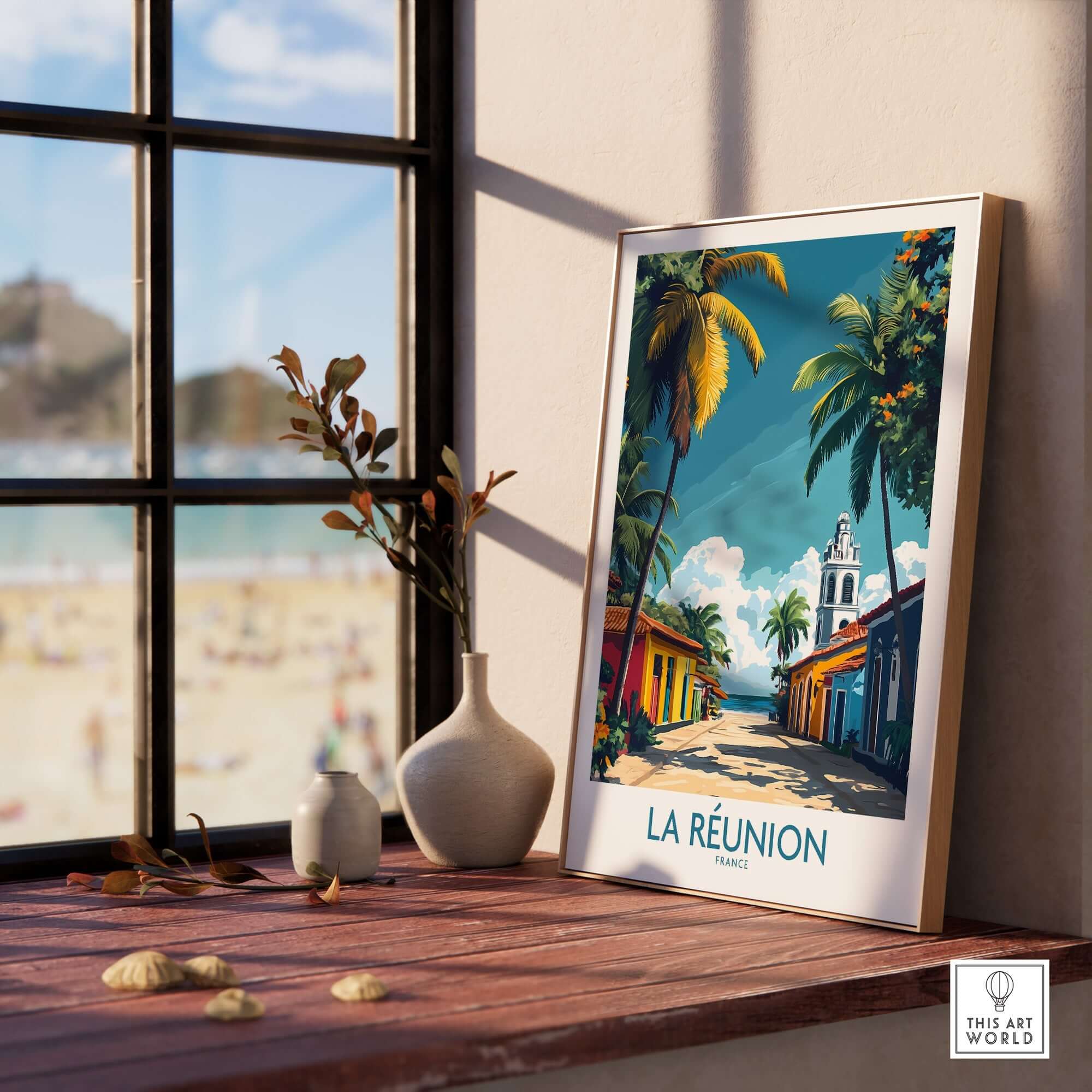 Réunion Island Wall Art Poster displayed on a wooden table by a window with a beach view.