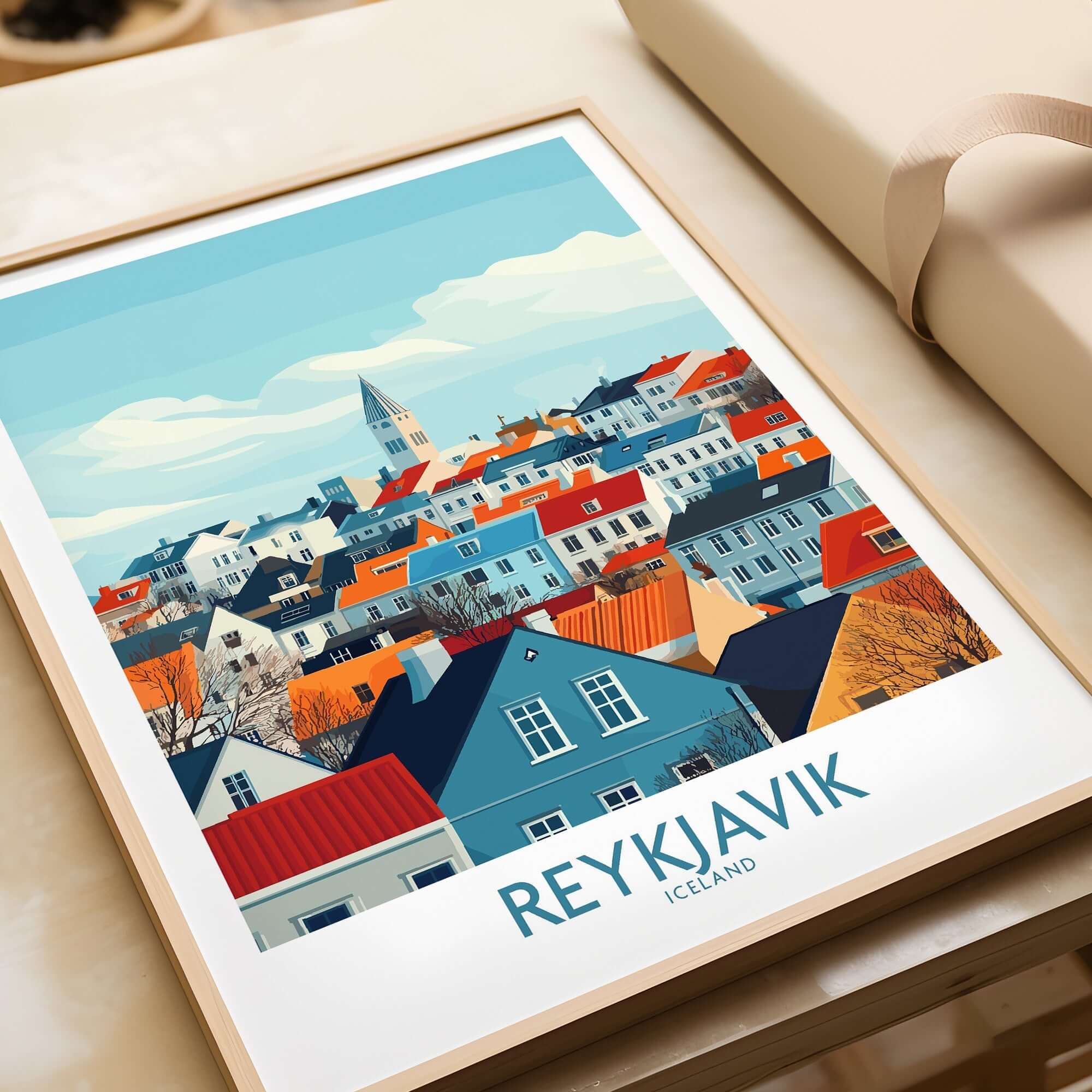 Reykjavik Wall Art Print showcasing colorful buildings in Iceland's capital city on a wooden table.