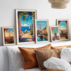 Rhodes Wall Art Print displayed alongside other travel art prints on a stylish bedroom wall.