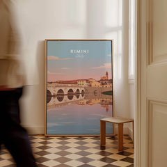 Rimini Italy Wall Art Print | Historic Bridge Reflection Travel Poster displayed in a home interior with a person walking by.