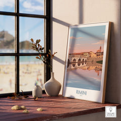 Rimini Italy Poster | Panoramic River Cityscape Scene Canvas Print displayed on a wooden table near a window.