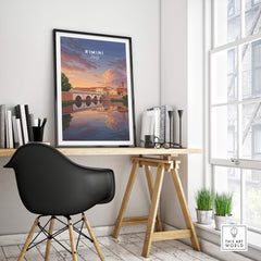 Rimini Italy Wall Art Print | Dramatic Sunset Over Tiberius Bridge Travel Poster framed on wall above a stylish desk.