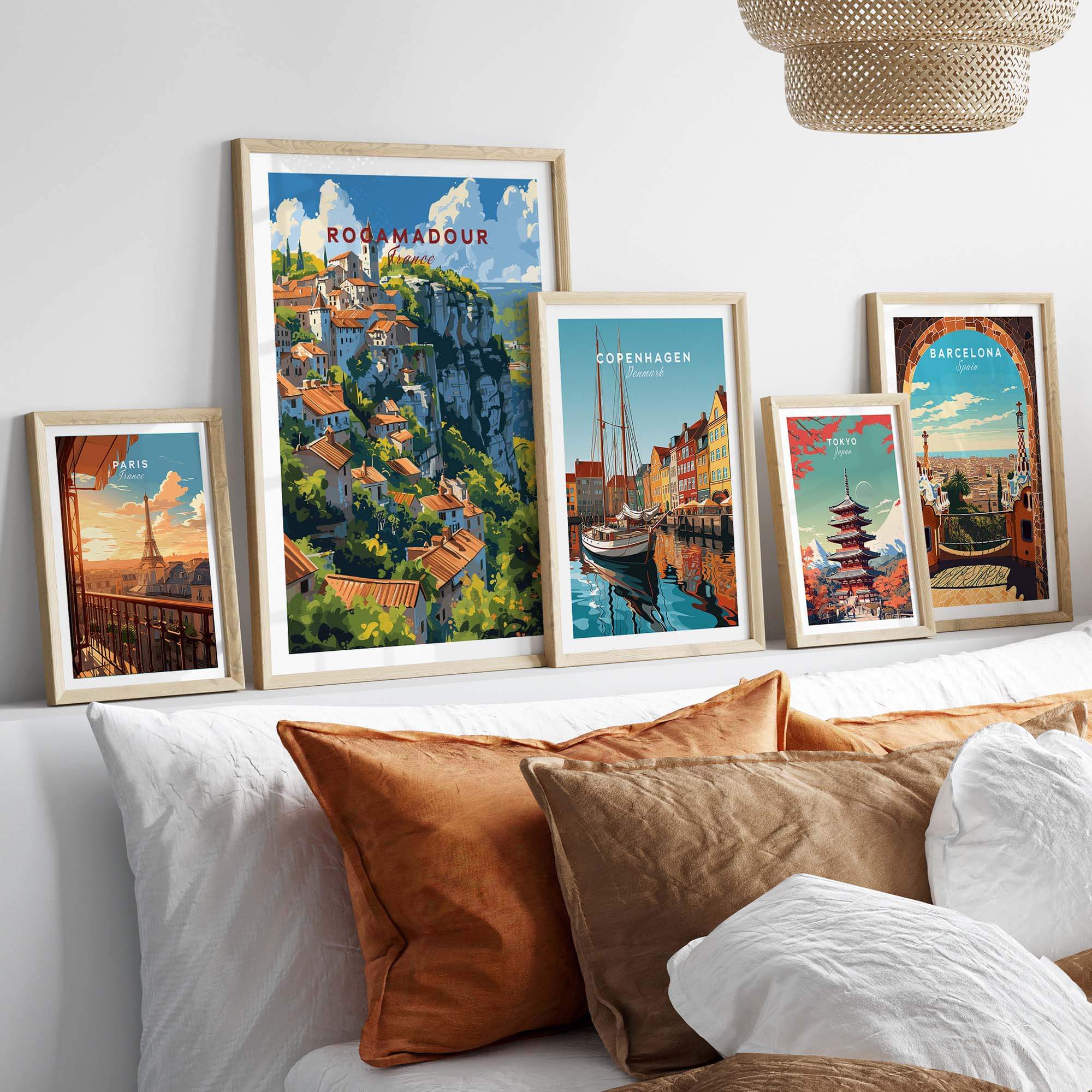 Framed Rocamadour travel poster among other city posters on a cozy sofa setting, highlighting French charm and travel aesthetic.