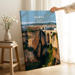Ronda Spain Wall Art Print | Panoramic Andalusian Cityscape Travel Poster displayed on a table with a vase of flowers.