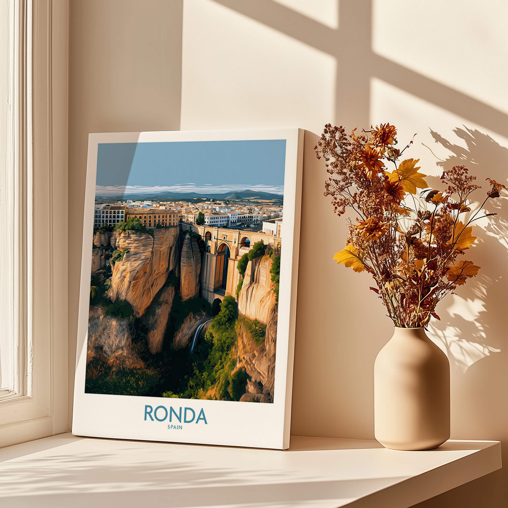 Ronda Spain Poster | Stunning Gorge Landscape Scene Canvas Print displayed on a windowsill with flowers.