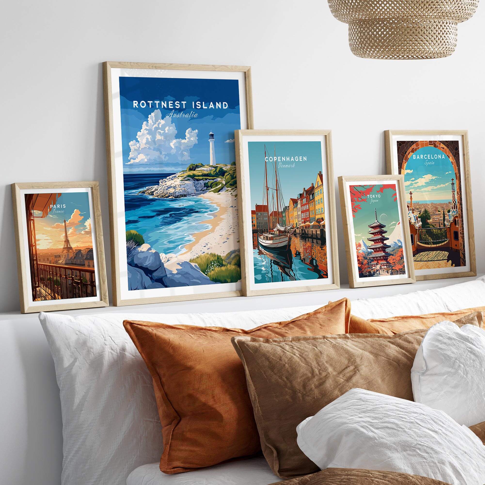 Rottnest Island Poster Australia displayed among other travel posters on a cozy couch with decorative pillows.