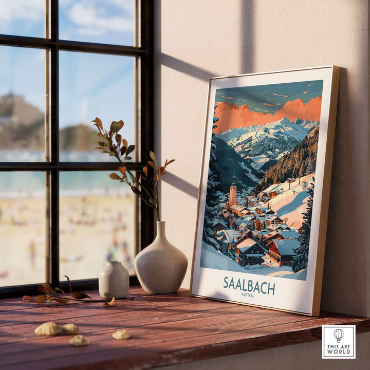 Saalbach ski poster art placed on a windowsill, showcasing a snowy alpine landscape, perfect for wall decor.