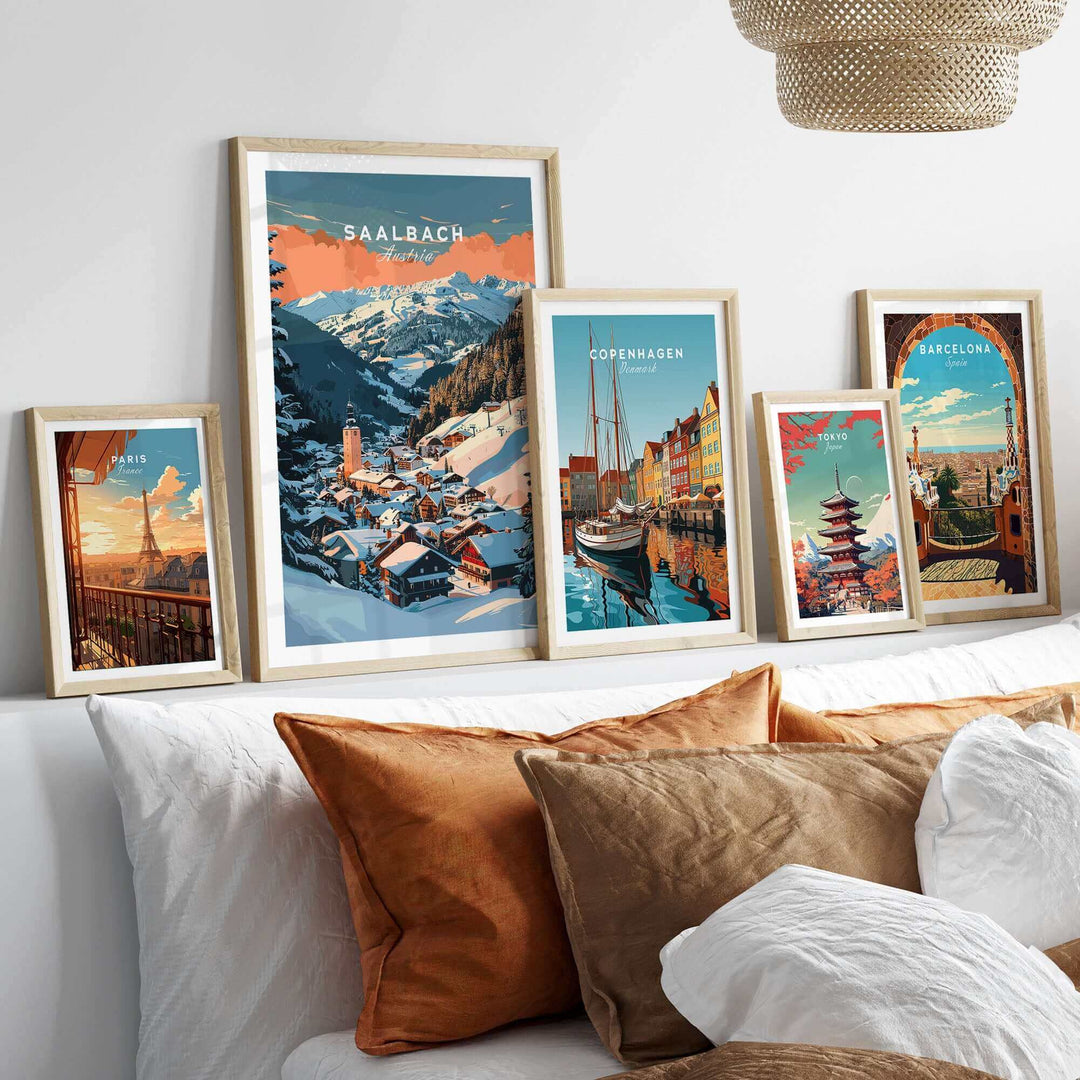 Saalbach ski poster wall art print displayed with other travel-themed posters in stylish wooden frames above a cozy sofa.