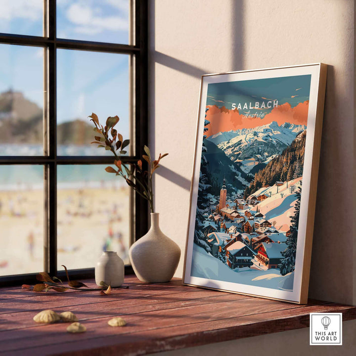 Saalbach ski poster wall art print displayed on a windowsill with scenic mountain view.