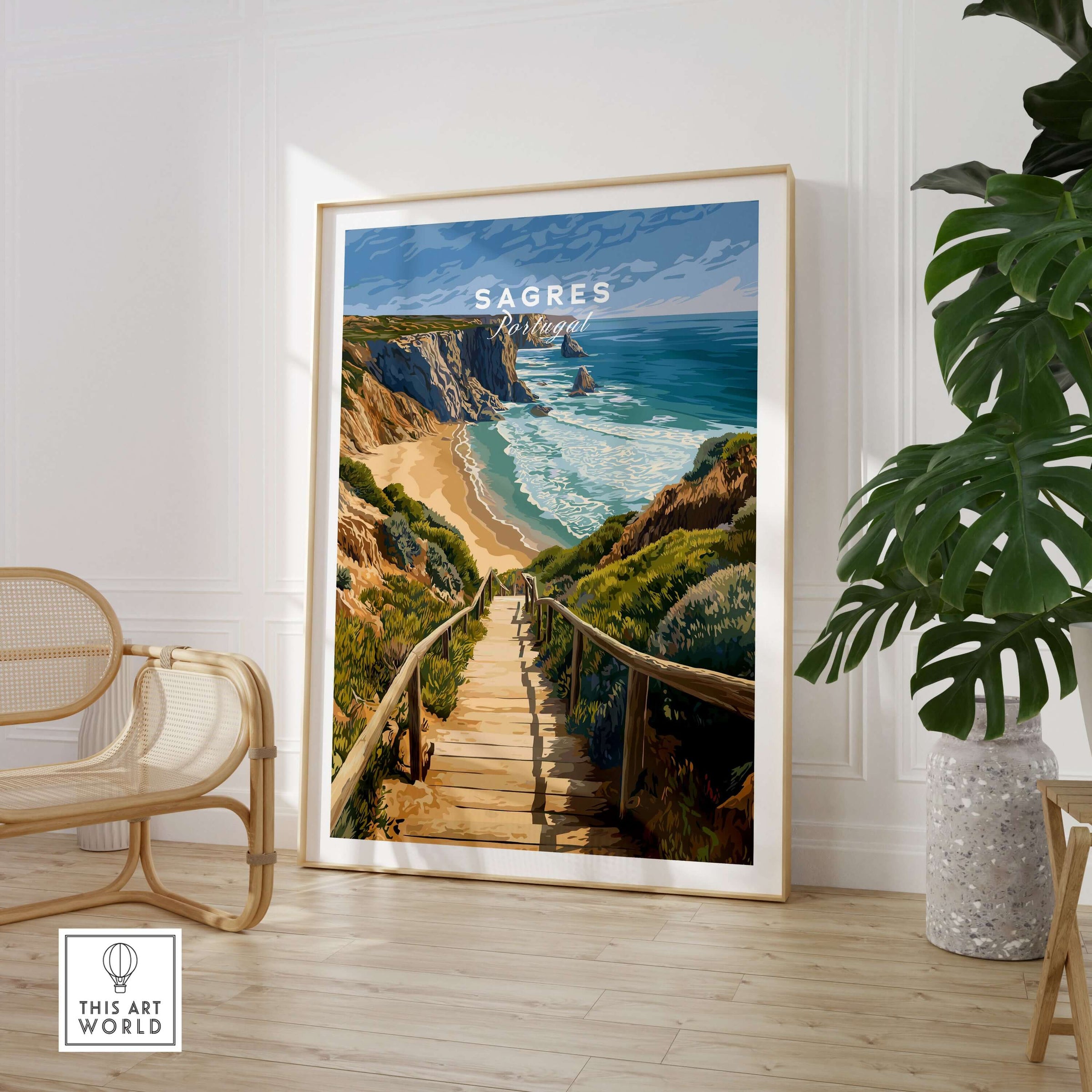 Sagres Algarve Cliffs Beach Print | Portugual Travel Wall Art showcased in a modern interior with a plant and chair.
