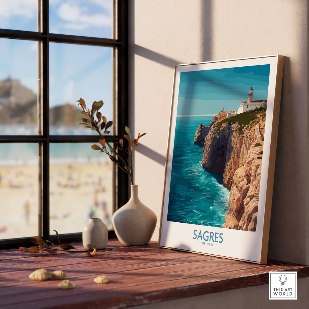 Sagres Portugal Cabo de São Vicente Art Print | Lighthouse Cliff Poster displayed on a wooden table near a window.