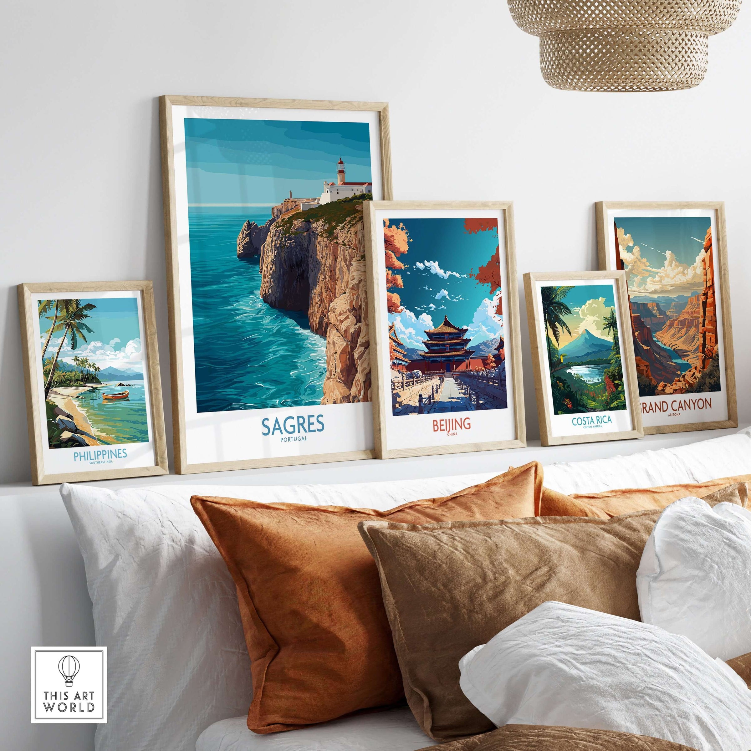 Sagres Portugal Cabo de São Vicente Art Print | Lighthouse Cliff Poster displayed among travel art prints on a sofa.