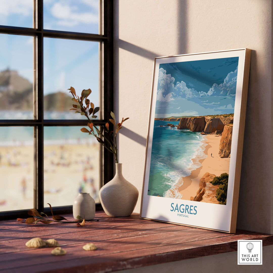 Sagres Portugal Golden Cliffs Beach Art Print | Algarve Coastal Poster displayed on a windowsill with a beach view.