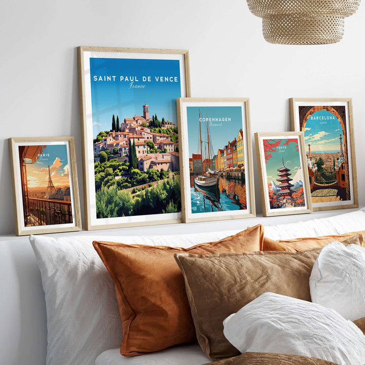 Saint Paul de Vence print alongside travel posters in a cozy bedroom setting with decorative pillows.