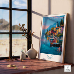 Salò Lake Garda Italy Sunset Art Print | Lakeside Boats Poster displayed in a sunlit room with a view of the beach.