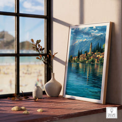 Salò Lake Garda Print | Italian Alps Wall Decor displayed on a wooden shelf by a window, showcasing stunning Italian scenery.