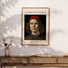 Botticelli Portrait Young Man Red Hat 1483 Art Print Renaissance Florentine Poster displayed on a stylish wall.