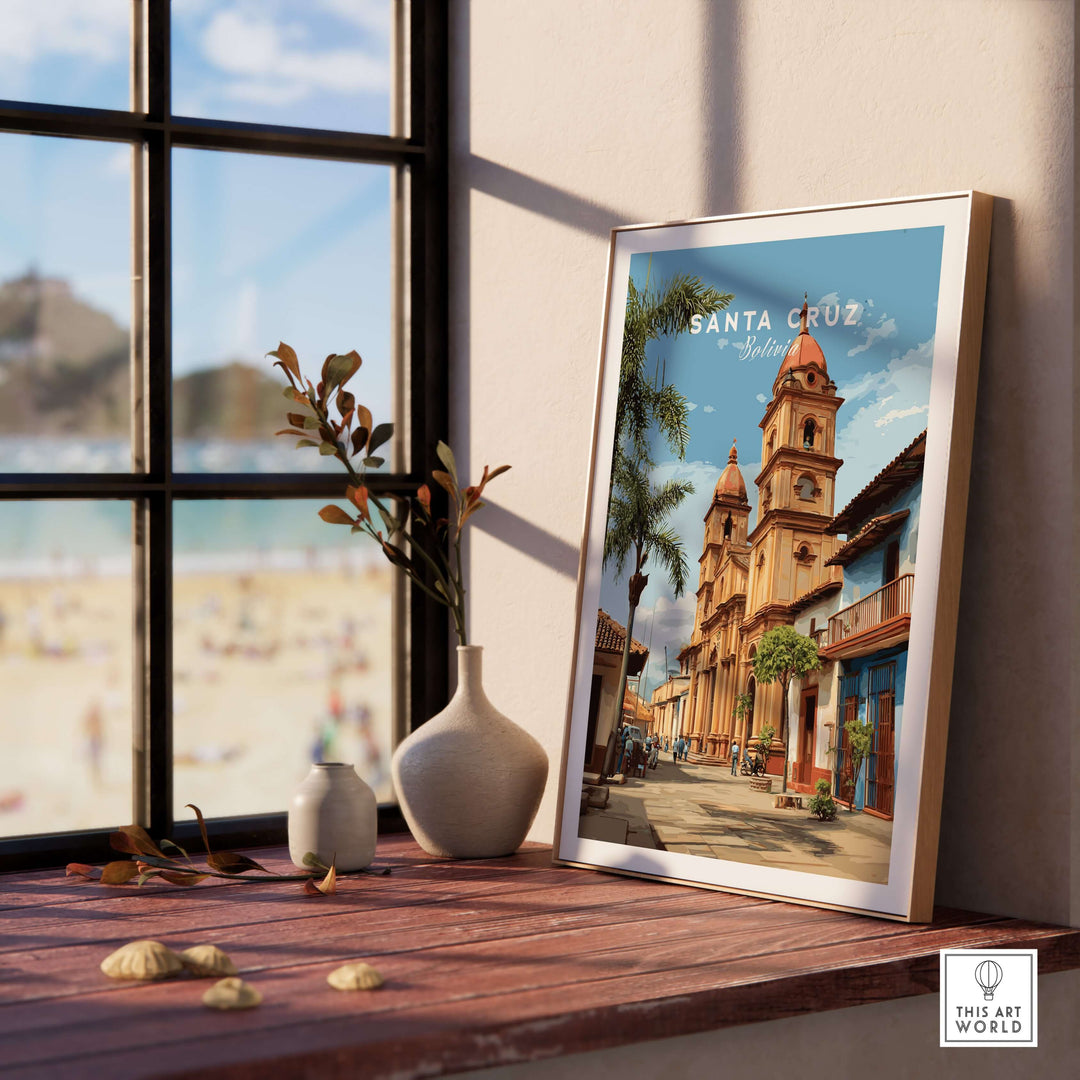 Santa Cruz Poster | Bolivian Travel Wall Art displayed on a wooden table with a beach view in the background.