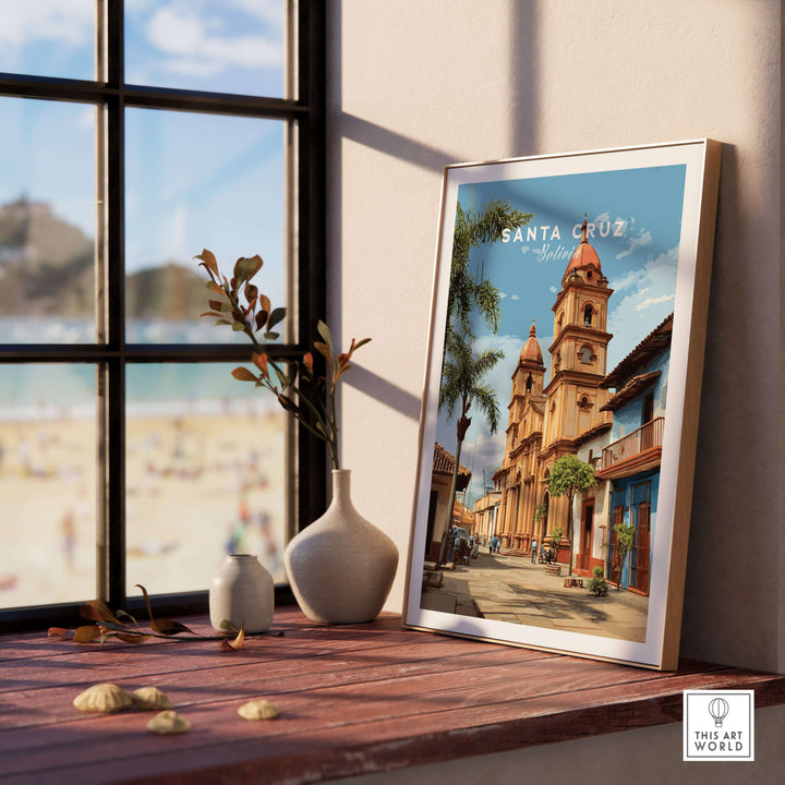 Santa Cruz Poster | Bolivian Travel Wall Art displayed on a wooden table with a beach view in the background.