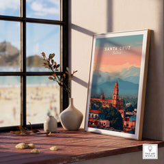 Santa Cruz City Print | Bolivian Home Wall Art displayed on a window sill with a beach view in the background.