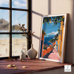 Sardinia Art Print - Coastal Landscape Wall Decor displayed on a wooden table with a beautiful beach view.