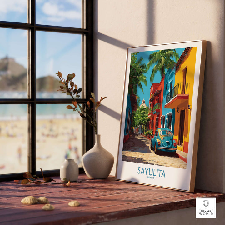 Sayulita Mexico Print | Colorful Street Poster framed on a wooden table with beach view in the background.