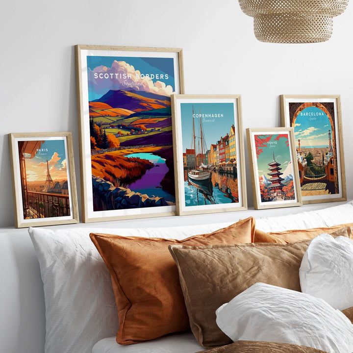 Collection of travel posters featuring Scottish Borders, Copenhagen, and Barcelona framed on a modern wall decor.