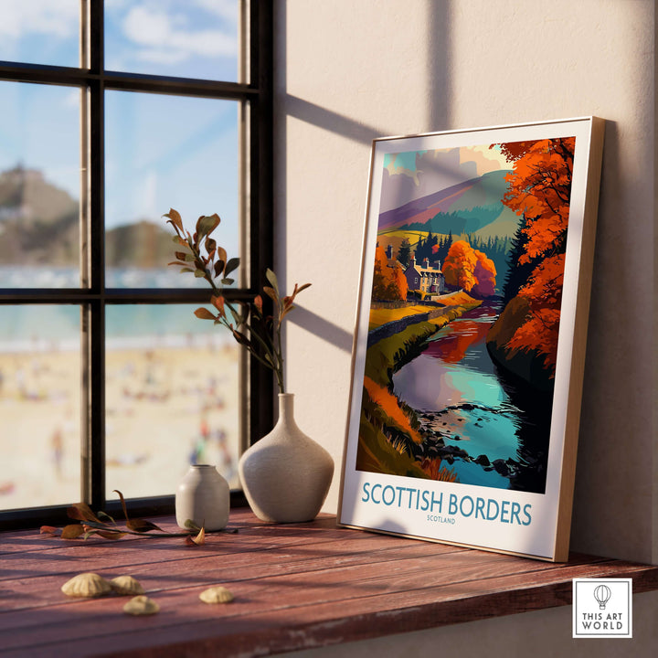 Scotland river landscape travel poster on a windowsill, showcasing autumn colors in the Scottish Borders.