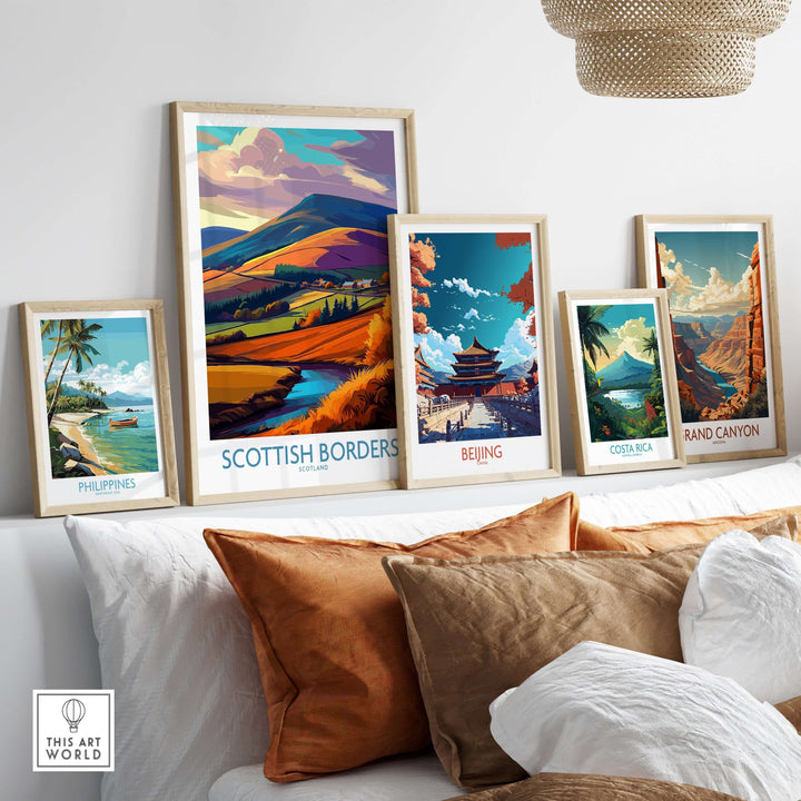 Collection of travel posters displaying Scotland, Beijing, Costa Rica, Philippines, and Grand Canyon art on a wall.