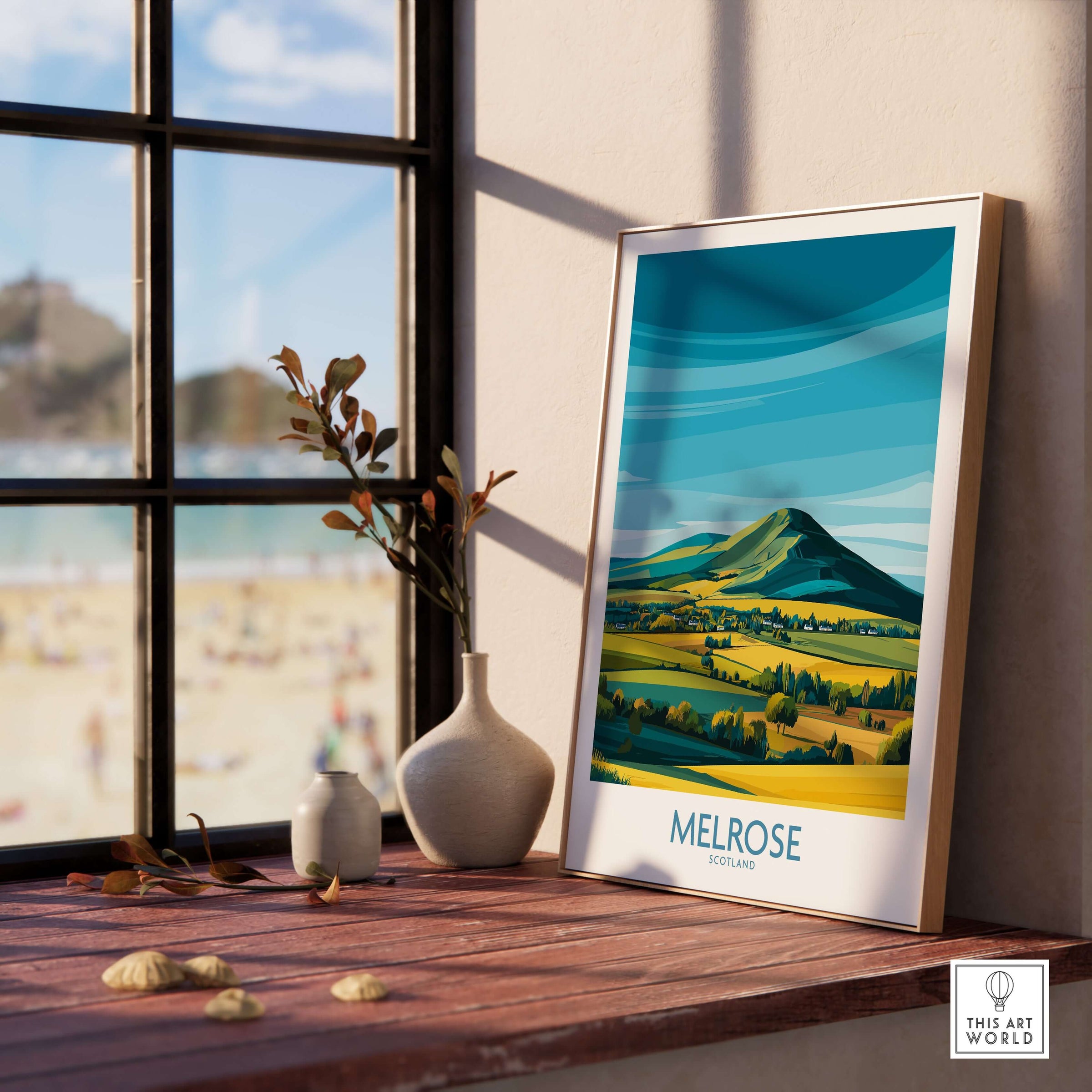 Scottish Borders Melrose Travel Print Eildon Hills Poster Modern Landscape Art displayed on a wooden table by a window.