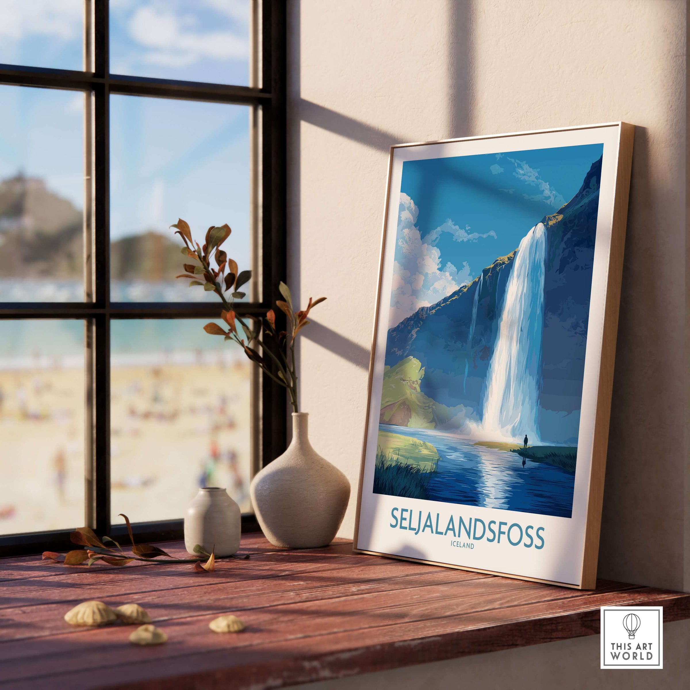 Seljalandsfoss Iceland Art Print displayed on a wooden table with a scenic background, showcasing the beautiful waterfall.