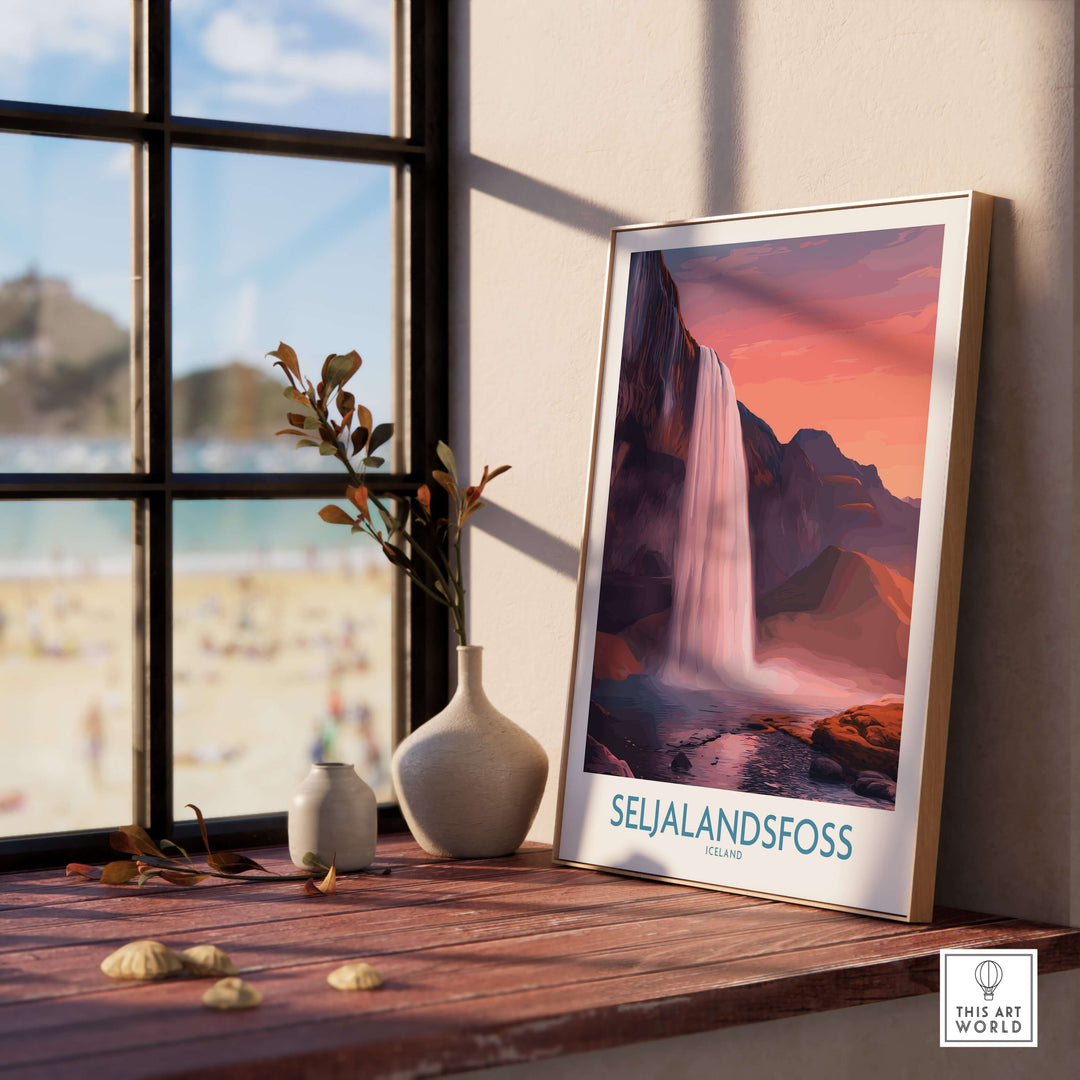 Seljalandsfoss Iceland Sunset Waterfall Art Print | Pink Sky Travel Poster displayed in a cozy interior setting.